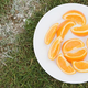 Orange slices on plate on soccer field